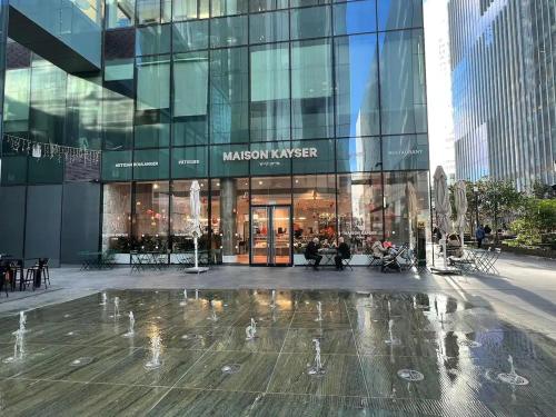 a glass building with a fountain in front of it at Midtown Tel Aviv Luxury Apartment in Tel Aviv