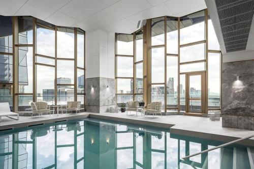 a pool in a building with windows at Spencer St 1bd Lvl 47 Melbourne CBD in Melbourne