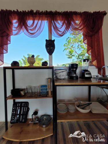 a window with a cat head sticking out of it at Vista al Volcán Tenorio y Montaña in San Rafael