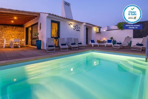 a swimming pool in front of a house at Villa Belize by Algarve Vacation in Albufeira