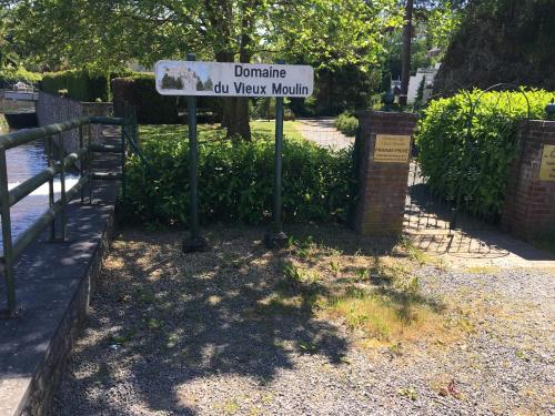 a street sign in a park next to a fence at Studio 12 in Han-sur-Lesse