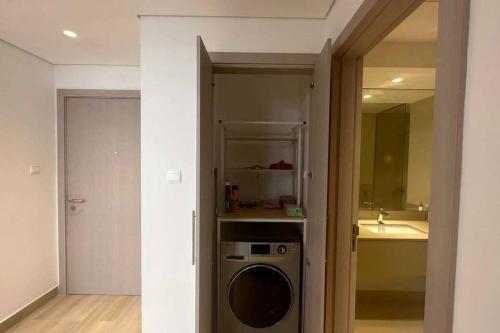 a bathroom with a washing machine in a room at The Sea World Lookout Loft in Abu Dhabi