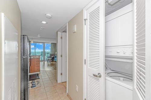 a kitchen with a washer and dryer in a house at Direct Oceanfront Condo-Sandy Beach Resort 1610- Sleeps 6! in Myrtle Beach