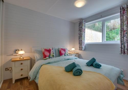 a bedroom with a large bed and a window at 11a Waterhead Close in Kingswear