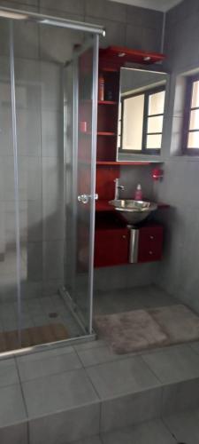 a bathroom with a shower and a sink at Holiday unit 54 Eden Dunes in Shelly Beach