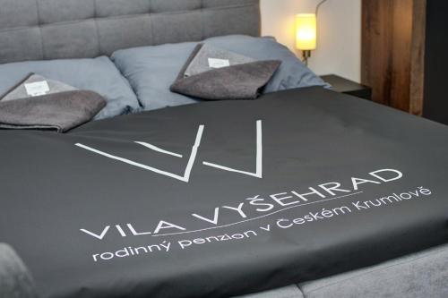 a bed with a valkyrieland reputationantom mattress on it at Vila Vyšehrad in Český Krumlov