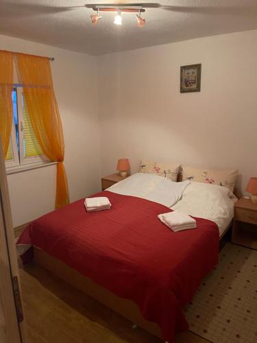 a bedroom with a bed with two towels on it at Apartments Marija in Vir