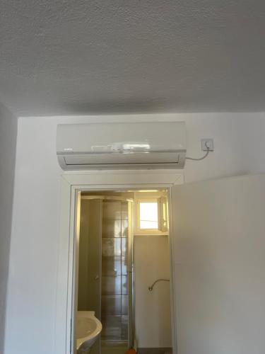 a bathroom with a white ceiling and a mirror at Apartments Marija in Vir
