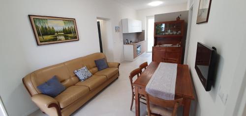 a living room with a couch and a table at casa nel verde della Val di Vara in Serò