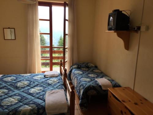 En eller flere senge i et værelse på Albergo Ristorante Pineta