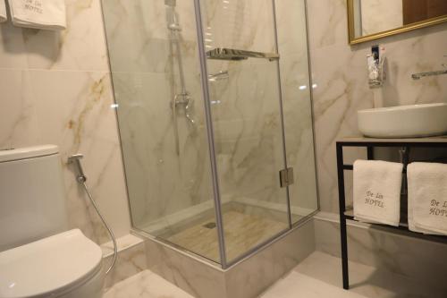 a bathroom with a shower with a toilet and a sink at DeLin Hotel And Tours in Yerevan