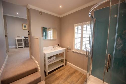 a bathroom with a sink and a shower at Strandene (63 Strand Road) in Portstewart