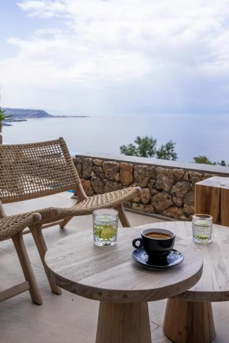 a wooden table with a cup of coffee on it at ​Le Grand Bleu Resort in Derveni