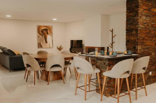 a living room with a dining table and chairs at Antas Villa Family in Esposende
