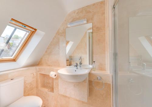 a bathroom with a sink and a shower at Chart Cottage in Beer
