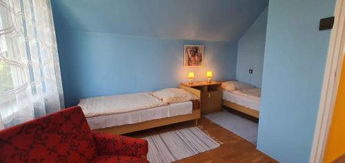 バラトンボグラールにあるApartment Balatonboglar 7のベッド2台と椅子が備わる小さな客室です。