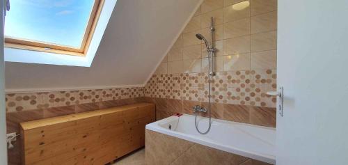 a bathroom with a shower and a bath tub at Apartment Balatonboglar 7 in Balatonboglár