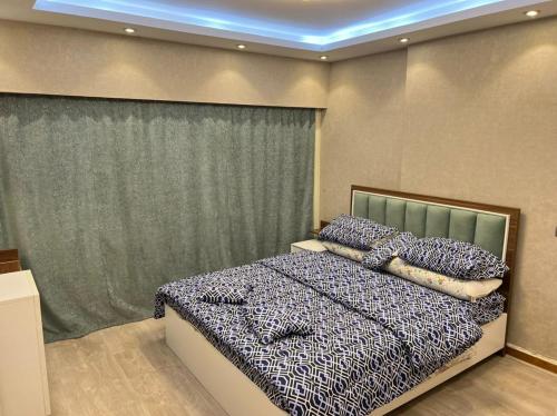 ein Schlafzimmer mit einem Bett mit Kissen darauf in der Unterkunft شقة للايجار في الزمالك in Kairo