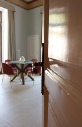 an open door to a room with a table at Palazzo sul Corso-Charming Appartaments in Brindisi