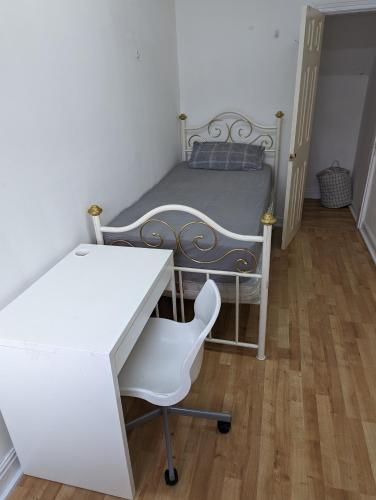 a bedroom with a bed and a desk and a chair at Oldham town centre rm02 in Oldham