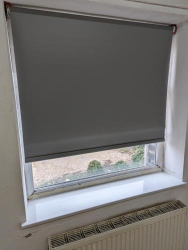 a window with a rolled up window shade on it at Oldham town centre rm02 in Oldham