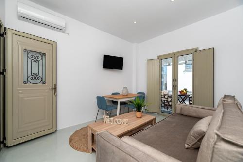 a living room with a couch and a table at Aerenia Luxury Suites in Karterados