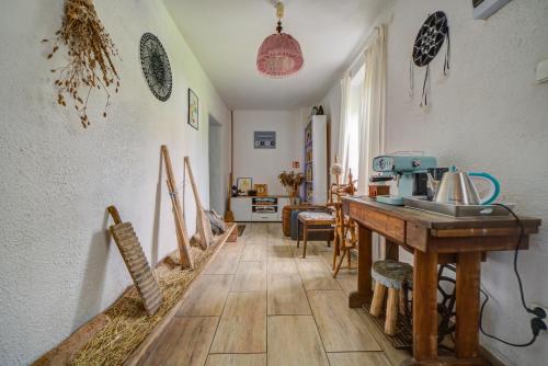 a room with a wooden table and a kitchen at Uroczysko Skomackie in Stare Juchy