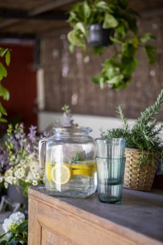 a jar of lemonade and a glass cup on a table at unic views begur, alojamiento turístico in Begur
