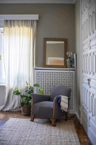 a living room with a chair and a mirror at unic views begur, alojamiento turístico in Begur