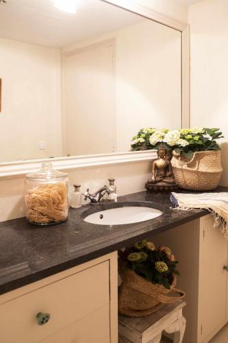a bathroom with a sink and a large mirror at unic views begur, alojamiento turístico in Begur