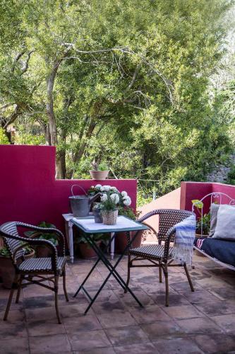 a table and chairs on a patio with trees at unic views begur, alojamiento turístico in Begur