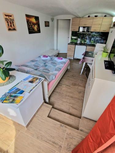 a small room with a bed and a desk at Apartments Karin in Bled