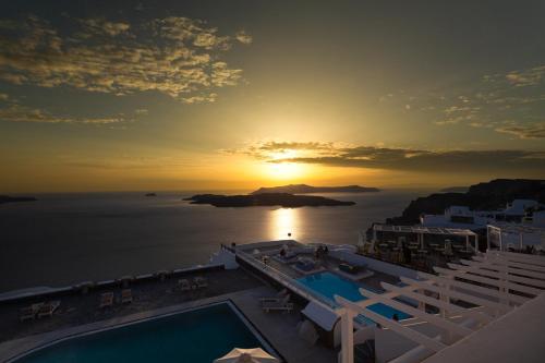 a view of the sun setting over the ocean at Caldera Butterfly Villas in Fira