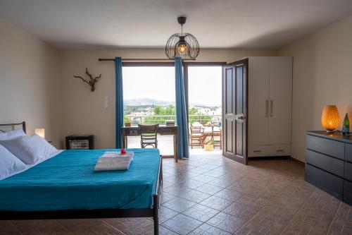 a bedroom with a bed and a view of a balcony at Kalithea Studio 1 in Palekastron