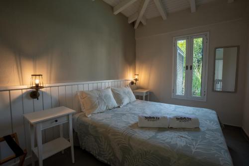 a bedroom with a bed with two boxes on it at Sedirli Ev in Alacati