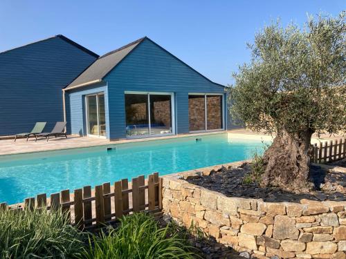 a house with a swimming pool in front of a house at Le Clos de Kermadec in Kervignac