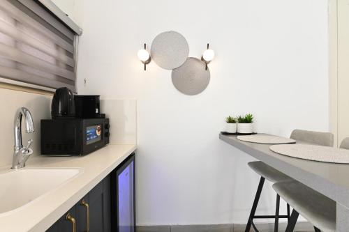 a kitchen with a counter with a sink and a microwave at YalaRent - Liri Resort in Tiberias