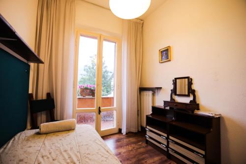 a bedroom with a bed and a dresser and a window at GlampingCashmereHause in Rivotorto 