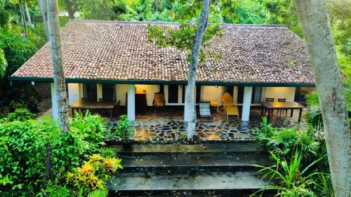 a house with stairs leading up to it at Whispering House in Tangalle