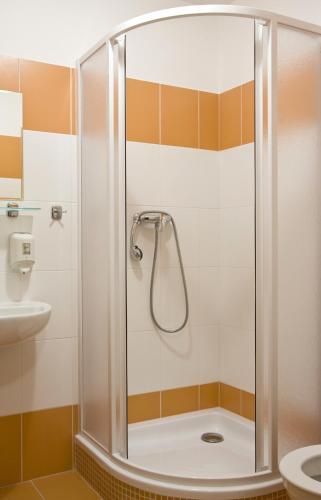 a shower with a glass door in a bathroom at Chata Nisanka in Bedřichov