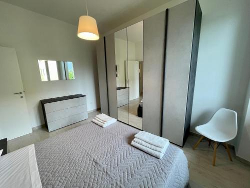 a bedroom with a bed and a chair and a mirror at Dama Dama in Guardiagrele