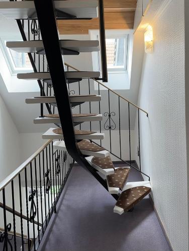 a spiral staircase in a house with a skylight at Hotel Peters Schwalbennest in Neuharlingersiel