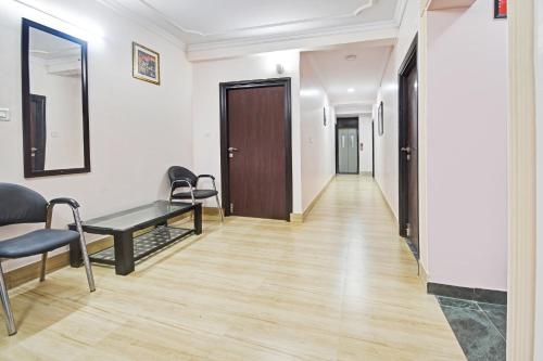 a corridor of an office with a desk and chairs at OYO Flagship 75407 Hotel Jaipur Home Stay Hawa Sadak in Jaipur