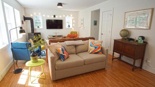 a living room with a couch and a television at Secluded Streamside Home with Hot Tub in Margaretville