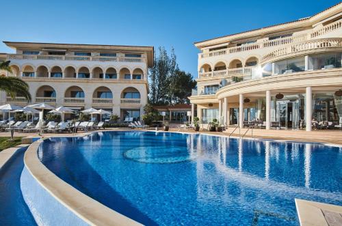a large swimming pool in front of a building at Pure Salt Port Adriano - Adults Only in Santa Ponsa