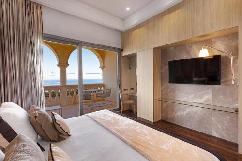 a hotel room with a large bed and a television at Pure Salt Port Adriano - Adults Only in Santa Ponsa