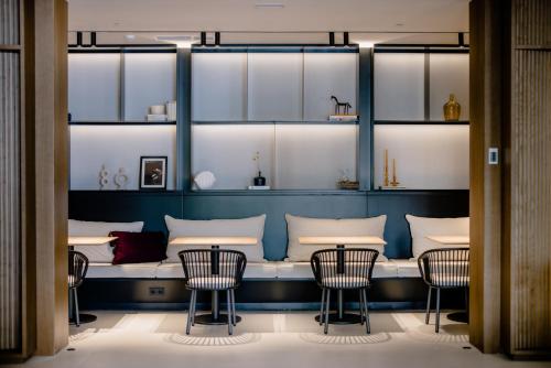a dining room with chairs and a bench with tables at THE FLAG HOTEL Marbella, Estepona Adult Recommended in Estepona