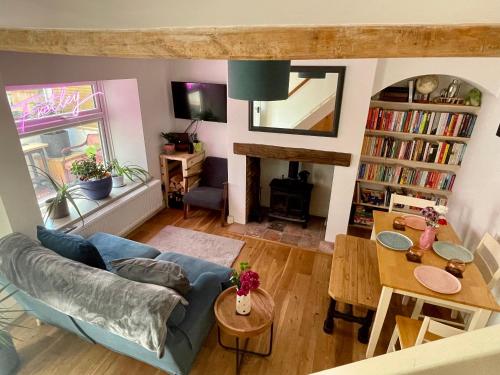 a living room with a couch and a table at Quiet & Cosy 2-Bedroom Cottage in Coltishall in Coltishall