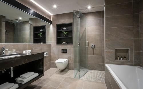 a bathroom with a shower and a toilet and a tub at Dingle Skellig Hotel in Dingle