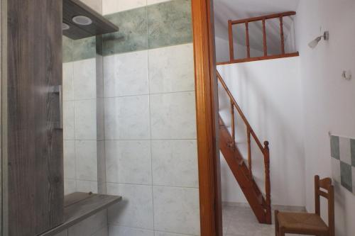 a bathroom with a shower and a staircase at Anastasia Apartments (Chorio) in Symi